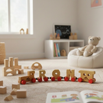 Wooden toy train set on a carpeted floor with books and a teddy bear in the background. 3