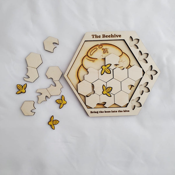 Hexagonal wooden puzzle with bee design on a white background