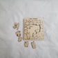 Wooden puzzle with cat-themed pieces on a white background