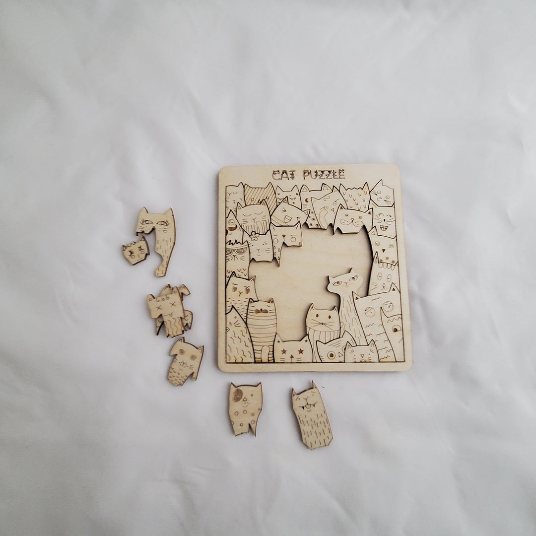 Wooden puzzle with cat-themed pieces on a white background