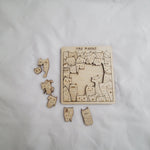 Wooden puzzle with cat-themed pieces on a white background 6