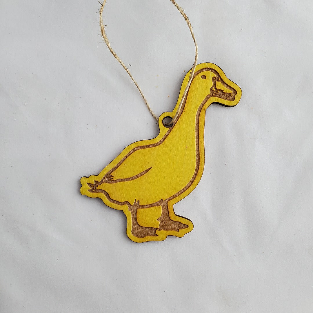 Yellow duck-shaped ornament on a white background