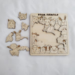 Wooden farm animal puzzle with pieces on a white background 11