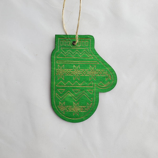 Green mitten ornament with patterns on a white background