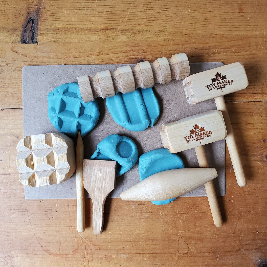 Wooden toy tools and stamps on a wooden surface