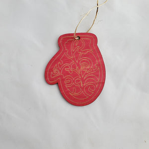 Red mitten ornament with patterns on a light gray background