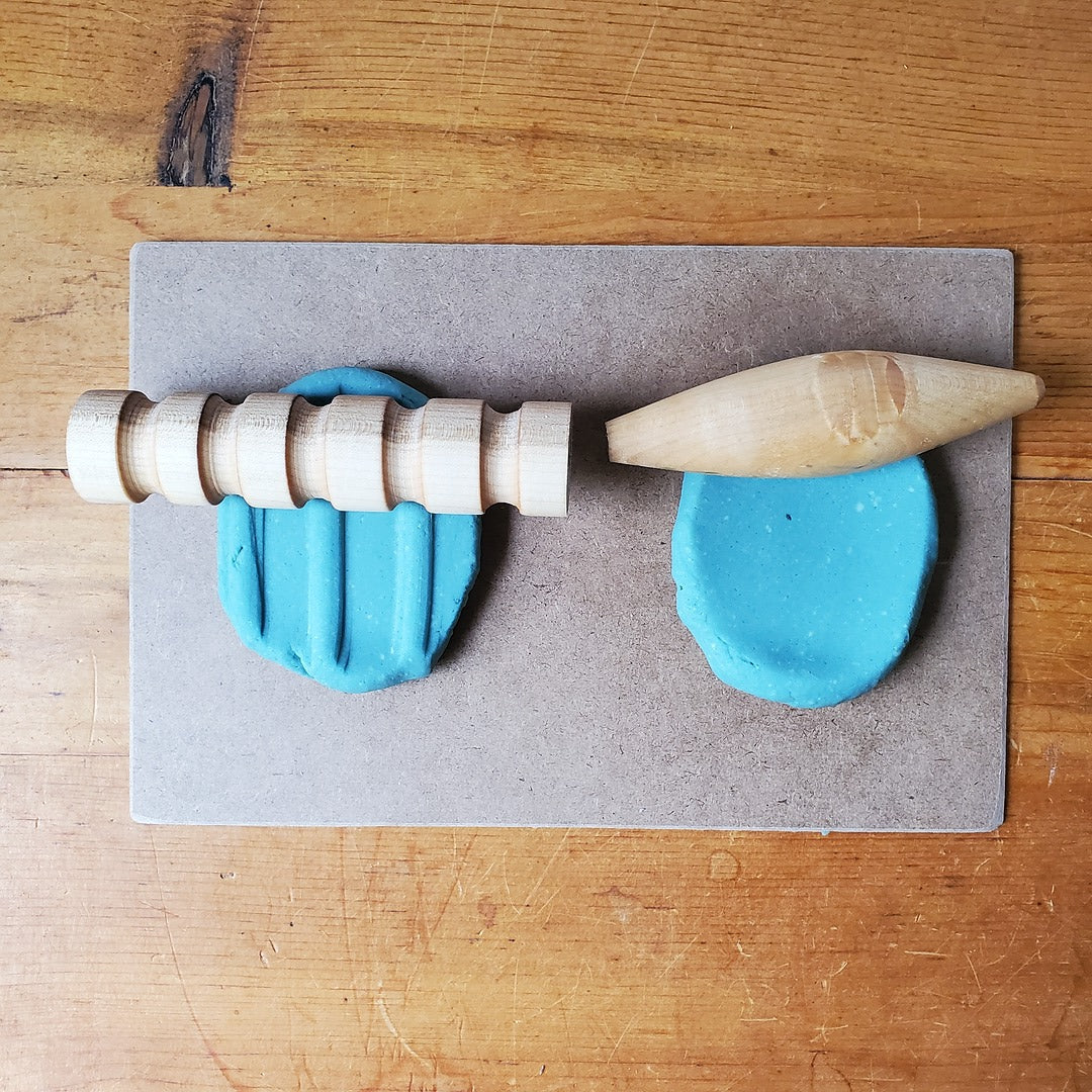 Wooden rolling pin and blue play dough