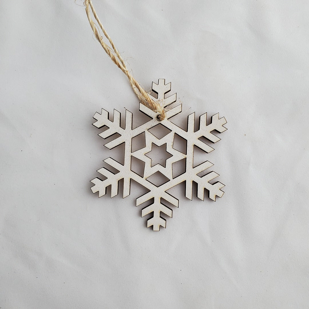 Wooden snowflake ornament on a plain background