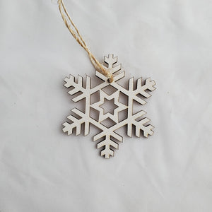 Wooden snowflake ornament on a plain background