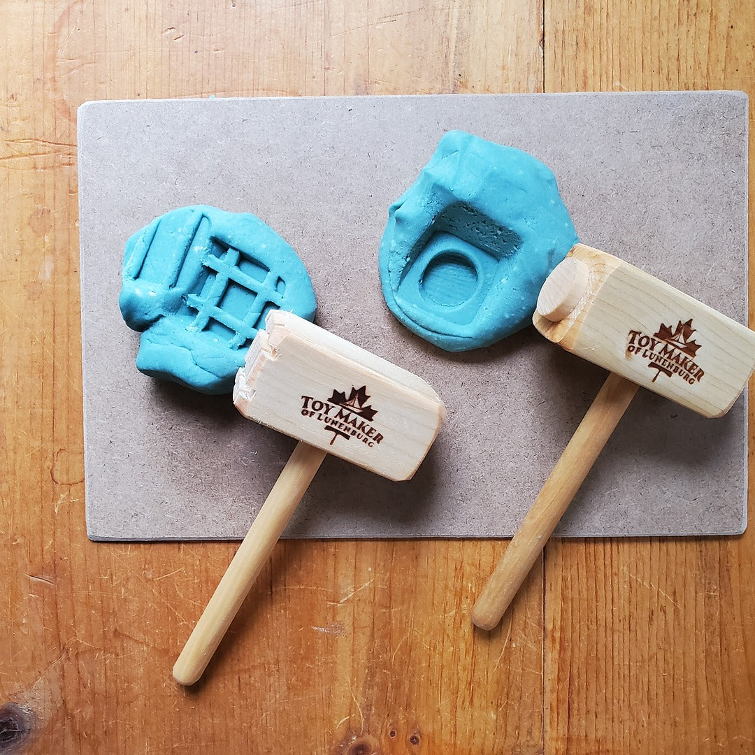 Two blue play-doh molds with wooden sticks on a gray mat, branded 'Toy Maker Playdough'.