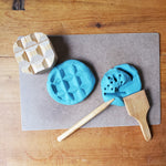 Blue play dough with wooden tools on a wooden surface 10