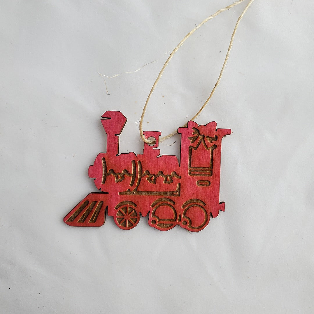 Red train ornament with accents on a white background